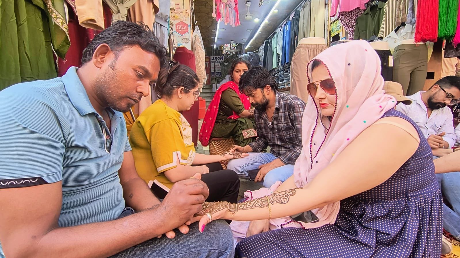 29. रोहतक स्थित किला रोड पर मेहंदी लगवातीं महिलाएं। संवाद