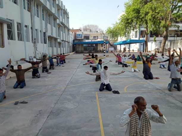 labourers are doing yoga in shelter hom in Rewari