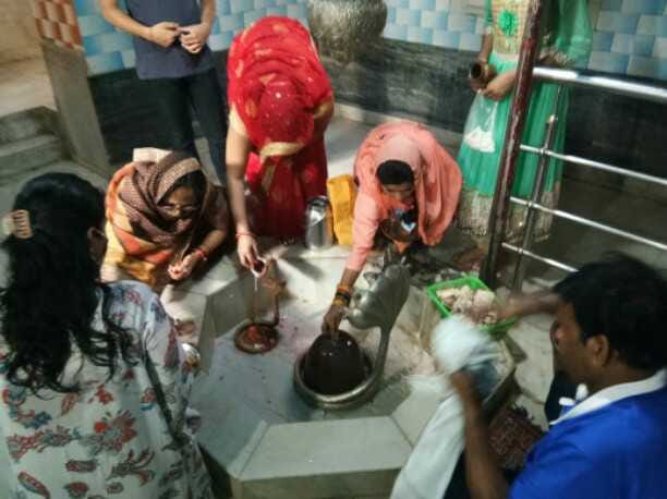 शिवलिंग पर जल अर्पित करते श्रद्धालु