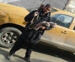Abu Rumaysah, posing with his child and AK 47, in a picture he shared on twitter