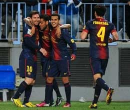 barcelona tops malaga and reaches copa semis