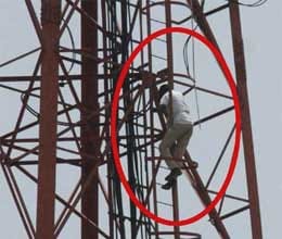 man climb rail tower due to trecktor need