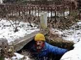 man lives into a 100-year-old grave after losing his house