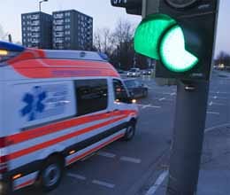 traffic signal change its color to see ambulance on road
