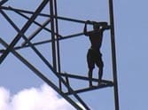 young man climbed on the tower in delhi.