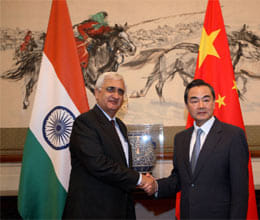 salman khurshid meets chinese foreign minister wang yi