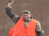 man catches flying bird with bare hand 