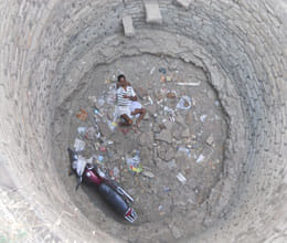 man falls in well