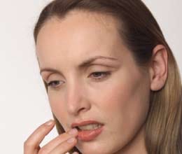 woman glueing her lips together