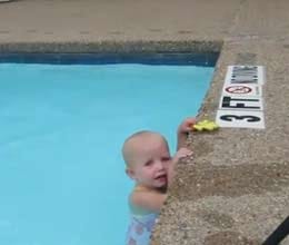 baby swims across pool