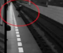 crazy woman falls onto railway track
