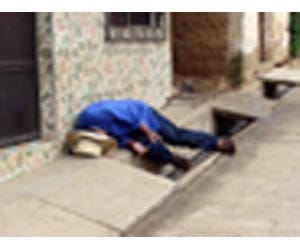 Takes a drink on the street
