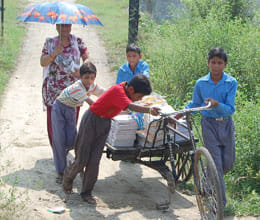 students pulling cart in the sun