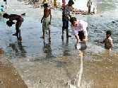 Two students immersed in Yamuna
