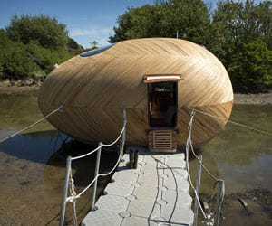 an egg: Giant floating wooden pod is artist's studio and home