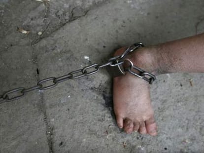 boy chained up like a dog 
