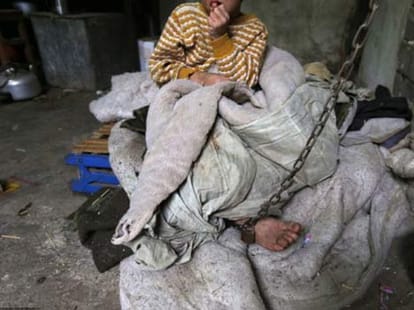 boy chained up like a dog 