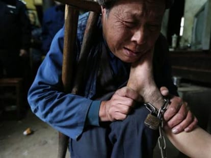 boy chained up like a dog 