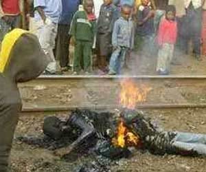 homosexual burned in front of public