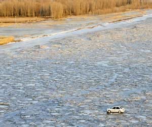 car driving on river