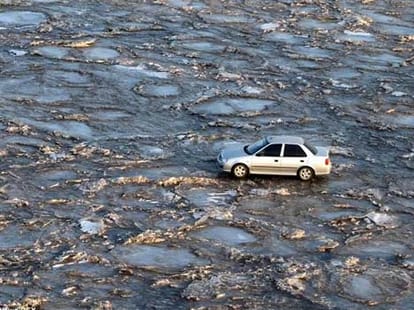 car driving on river
