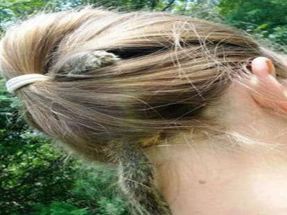 girl dons unique hairstyle, puts squirrel in hair