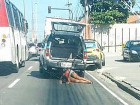 dead women dragged behind a police car after a crossfire