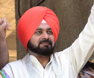 The audience laughs Sidhu