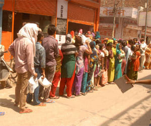 people are standing in que for ration