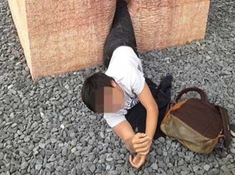 man stuck inside stone sculpture depicting vagina