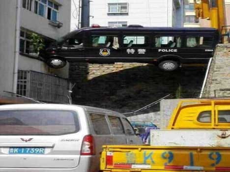 police van left suspended at a three storied building