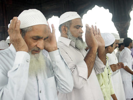 muslims offering prayers in mosque
