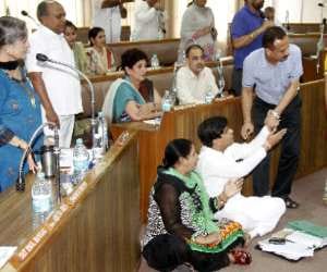 Councillor sitting on ground for problems