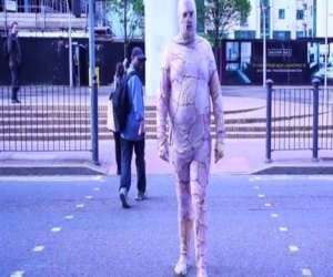 man walks out wearing body suit made of chicken