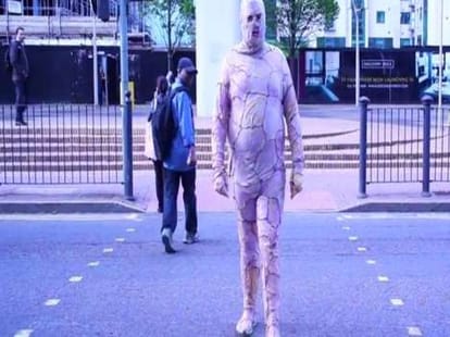 man walks out wearing body suit made of chicken