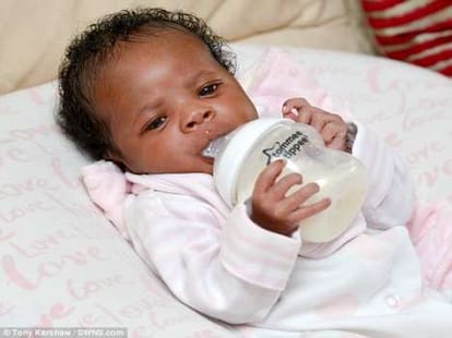 three days old newborn feeds herself