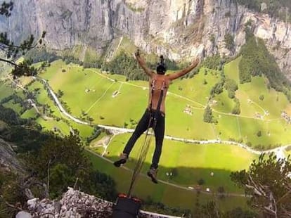 man hooks himself with parachute