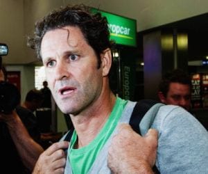 Chris Cairns cleaning bus shelters to provide for his family.
