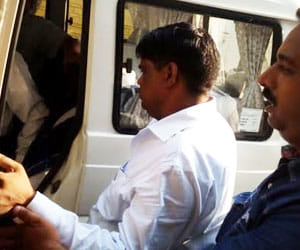 office arrested while taking bribe.