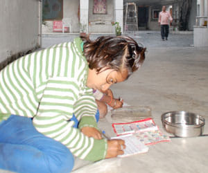children reading in temple while begging.
