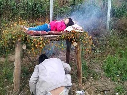 father puts his daughter on a smoking bed