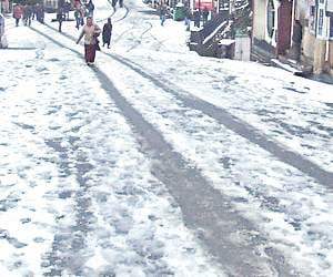 vehicles skid on the snow covered road.
