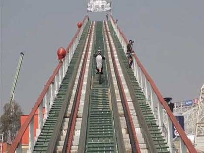 man rides motorcycle on roller coaster