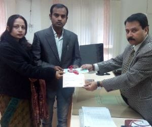 commisioner gives medal to intercaste and interreligion married couple.