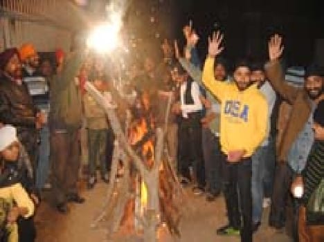 Sikhs celebrate Lohri festival fire circled