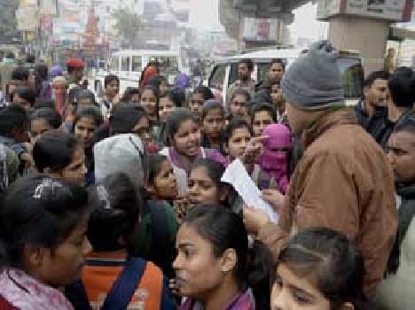 students on road against fee