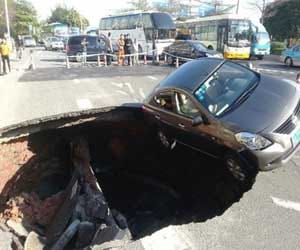 car inside sinkhole