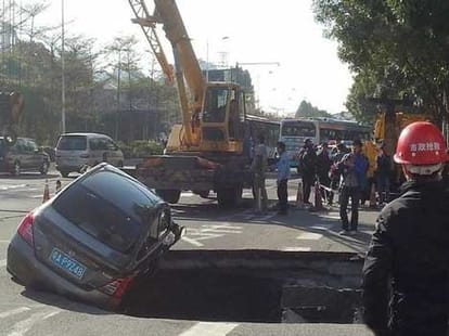 car inside sinkhole