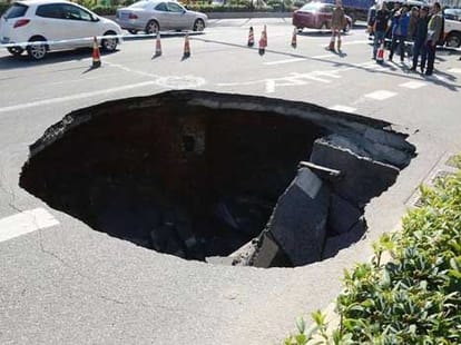 car inside sinkhole