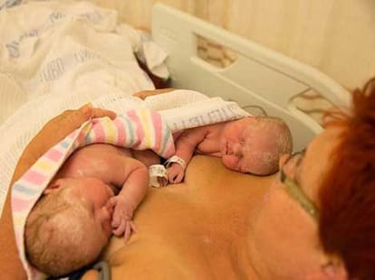mother reaches her tummy and pulls out twins